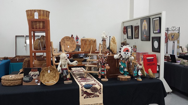 Art dealer selling vintage Native American baskets and drums