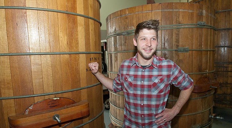 Oak & Ore's Micah Andrews with wooden brewing vats at Anthem Brewing Company, who's beer will be served in his new venue in the Plaza District. (Mark Hancock)