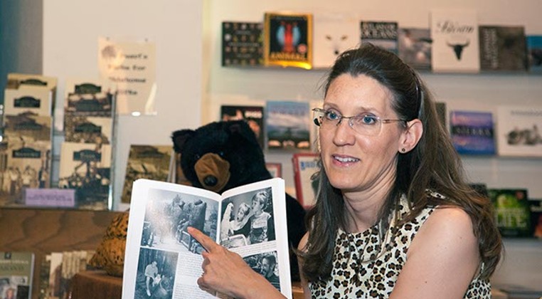 Amy Dee Stephens discusses a picture in her new Oklahoma City Zoo book, Sunday, 8-24-14, during a book signing event at Full Circle Bookstore. (Mark Hancock)