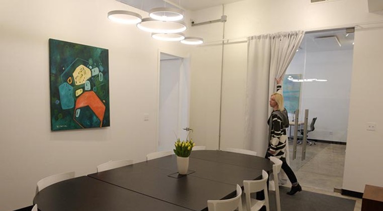 Erin Cooper shows off the conference room at Halcyon Works in the Paseo District (Garett Fisbeck)