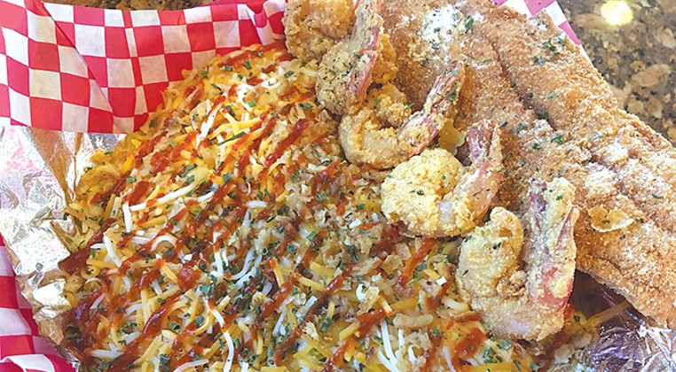 Smothered seafood is Off the Hook&#146;s most popular dish. A lobster sauce with a bevy of other seafood is poured over either rice or garlic fries. | Photo Jacob Threadgill