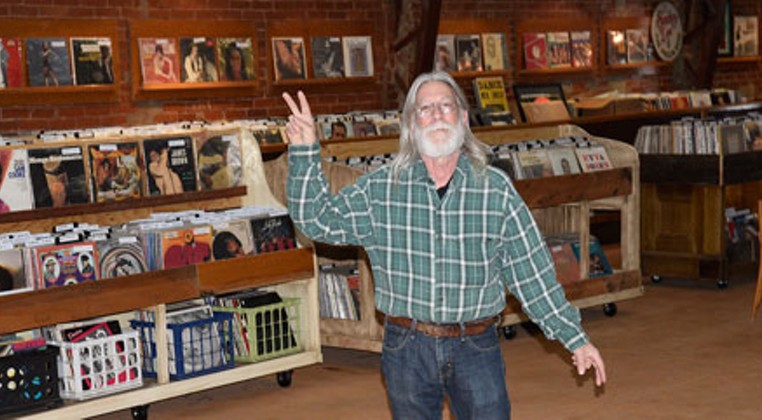 Trolley Stop Record Shop owner John Dunning keeps thousands of vinyl records in stock at his new store location in the old Penn Theater. (Photo Ben Luschen)
