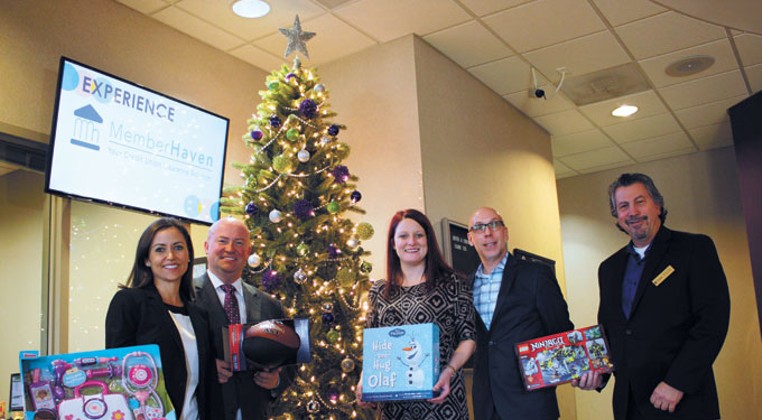 Community members from left Amber Jones, Joe Dorman, Miranda Hines, Scott Bell and Mitchell Rozin behind Oklahoma Institute for Child Advocacy and OK Foster Wishes&#146; gift drive for foster children and teenagers encourage the community to donate. | Photo Laura Eastes