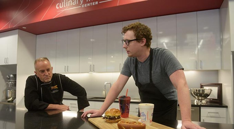 Scott Uehlein, Vice President of Product Development, and Jordan Denton, product developer, talk about some menu items in the works at Sonic's test kitchen, Monday, June 26, 2017. (Garett Fisbeck)