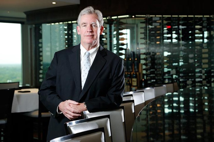 Kevin George pauses in front of the custom-built wall display of wines in The George Prime Steakhouse, his restaurant located atop Founders Tower. (Garett Fisbeck)