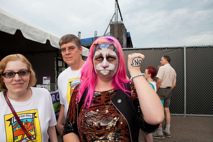 A festival attendee dressed as her favorite feline internet feline, Grumpy Cat