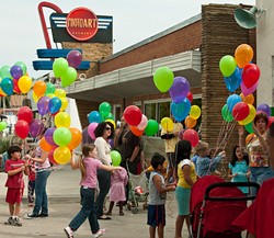 Balloons outside Photo Art Studio add even more local color to Plaza Fest, celebrating it's 16th birthday Saturday.