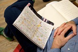 Josh Buss looks at a map of Oklahoma City while meeting with a group to discuss co-housing in Oklahoma City. (Garett Fisbeck)