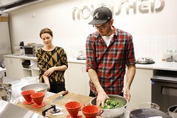 Lindsey Riddle and Jamie Conway prep kale at Nourished Food Co. in Oklahoma City. (Garett Fisbeck)