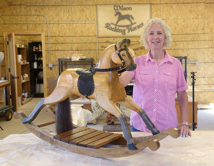 A Luther craftswoman constructs rocking horses by hand