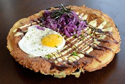 Okonamiyaki savory pancake with fried egg and red cabbage (Garett Fisbeck)