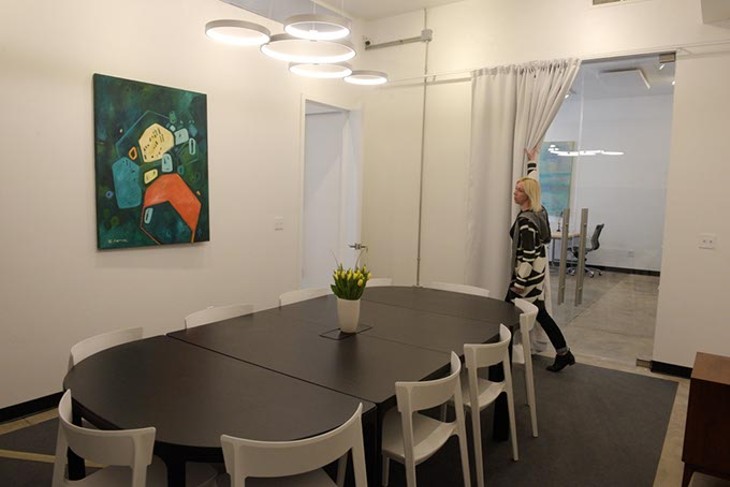 Erin Cooper shows off the conference room at Halcyon Works in the Paseo District (Garett Fisbeck)