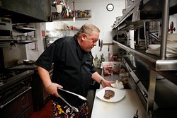 Owner and executive chef Bruce Rinehart plates a dish at Rococo. He and kitchen manager Josh Partain created a "restaurant within a restaurant" for Restaurant Week. (Garett Fisbeck / file)