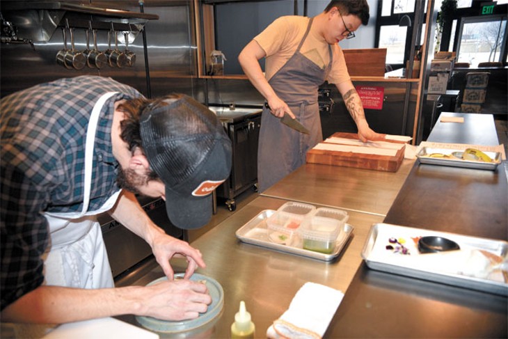 Chefs Colin Stringer and Paul Wang plate dishes inside the kitchen at Nonesuch. | Photo Jacob Threadgill