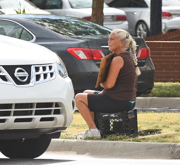 A woman begs for money from one of Oklahoma City&#146;s medians in 2015. (Photo Gazette/file)